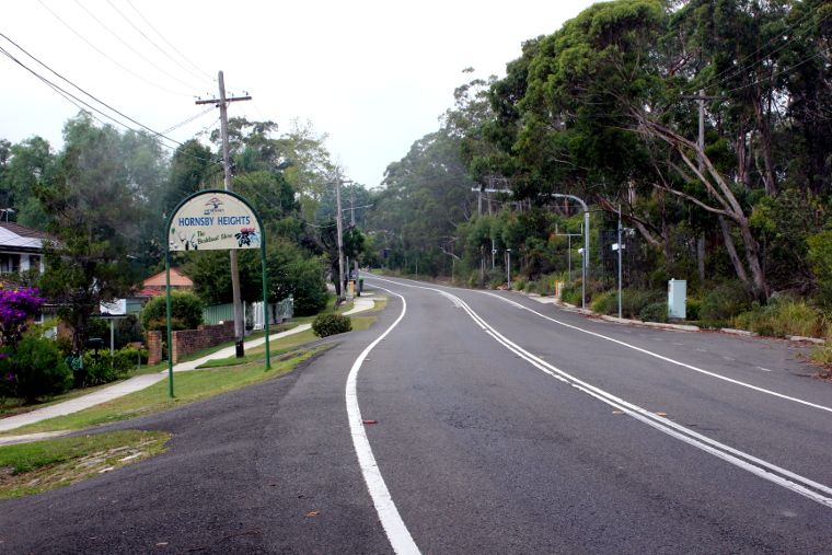 A Hornsby Heights town sign on the side of the road towards the end of the climb when cycling Galston Gorge East.