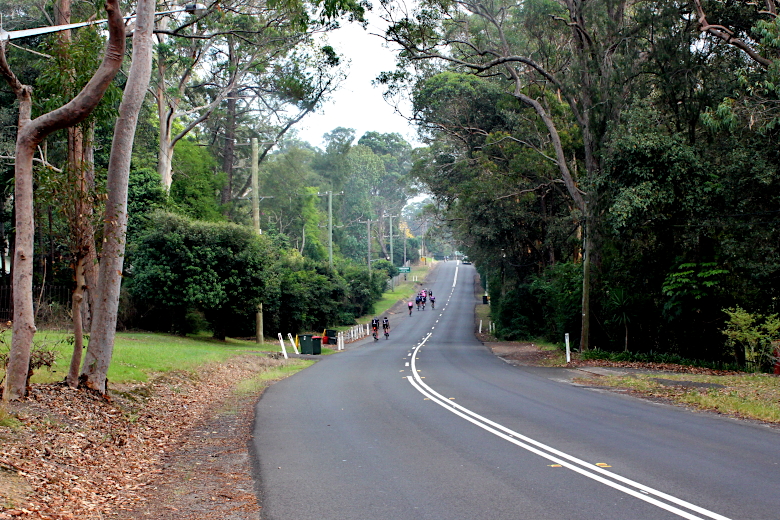 The top section of the hill with cyclists cycling Galston Gorge West.